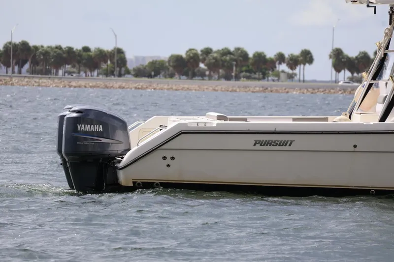 Slide: The Image of 2006 Pursuit 3070 Offshore boat with Yamaha outboard motor on water. - 4