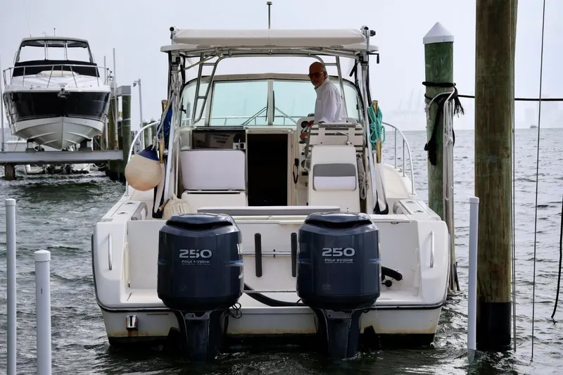 Slide: The Image of 2006 Pursuit 3070 Offshore boat docked with dual Yamaha 250 engines. - 6