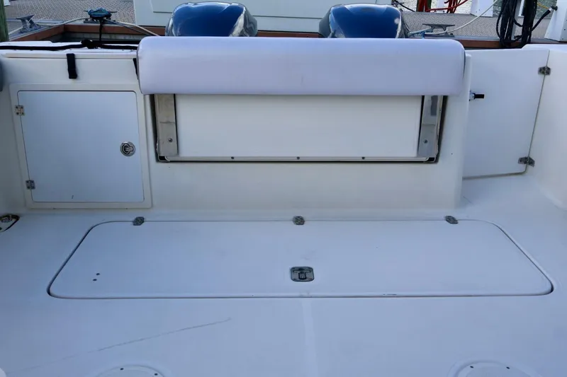Slide: The Image of 2006 Pursuit 3070 Offshore boat deck with storage compartments and seating. - 7