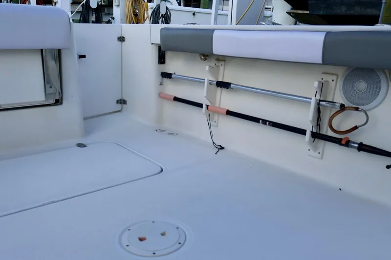 Slide: The Image of 2006 Pursuit 3070 Offshore boat interior with rod holders and storage compartments. - 8