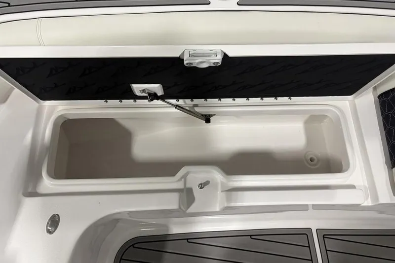 Slide: The Image of 2025 Tidewater 3100 Carolina Bay boat storage compartment with open lid and sleek design. - 10