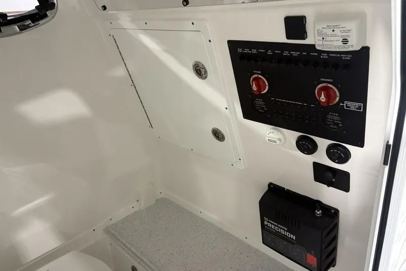 Slide: The Image of 2025 Tidewater 3100 Carolina Bay boat interior control panel and electrical system. - 20