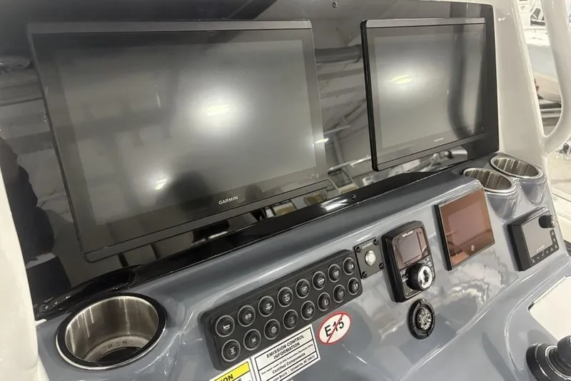 Slide: The Image of 2025 Tidewater 3100 Carolina Bay dashboard with dual Garmin displays and control panel. - 23