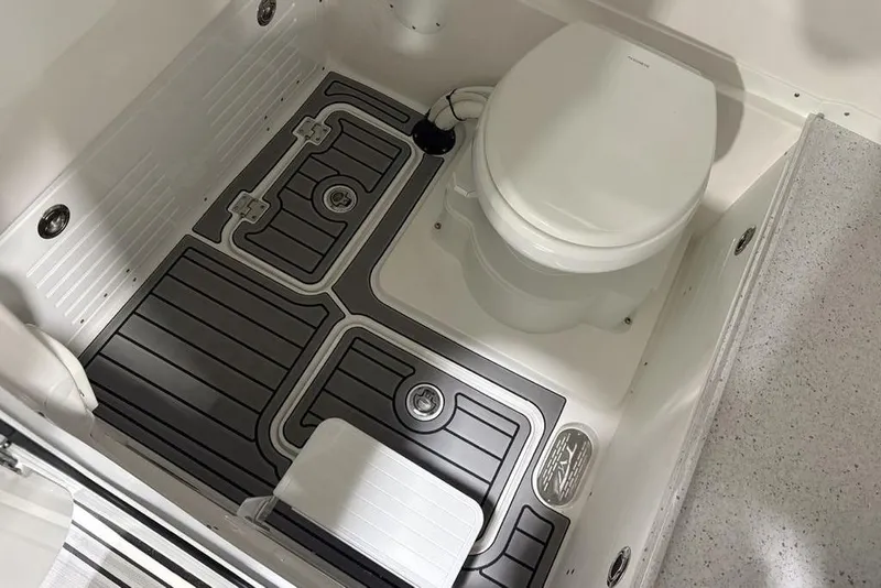 Slide: The Image of 2025 Tidewater 3100 Carolina Bay boat bathroom with modern flooring and toilet. - 25