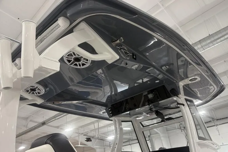 Slide: The Image of 2025 Tidewater 3100 Carolina Bay boat interior with speakers and rod holders. - 28