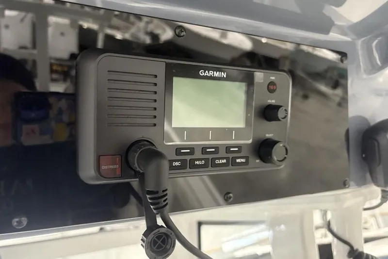 Slide: The Image of Garmin marine radio on 2025 Tidewater 3100 Carolina Bay boat dashboard. - 31