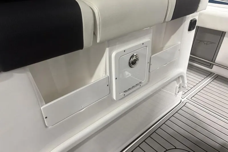 Slide: The Image of 2025 Tidewater 3100 Carolina Bay interior with storage compartments and cushioned seating. - 37