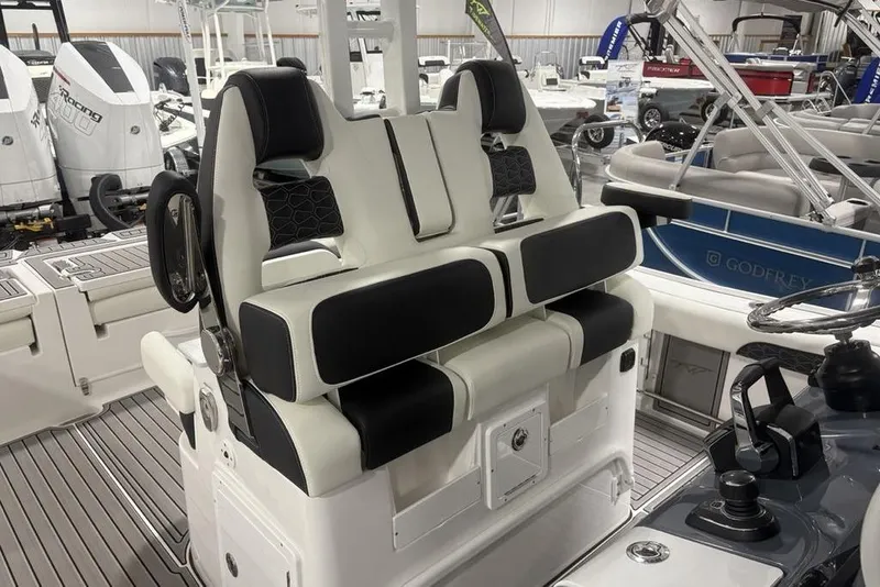 Slide: The Image of 2025 Tidewater 3100 Carolina Bay boat interior with dual seating and modern controls. - 39