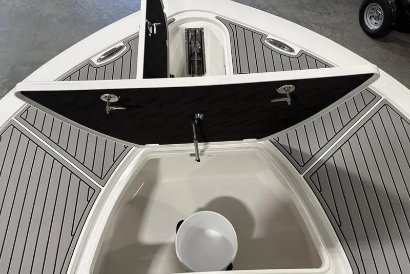 Slide: The Image of 2025 Tidewater 3100 Carolina Bay boat with open storage compartment and gray deck. - 4