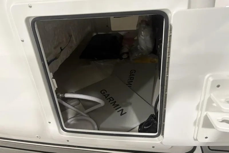 Slide: The Image of Storage compartment of 2025 Tidewater 3100 Carolina Bay boat with Garmin equipment. - 40