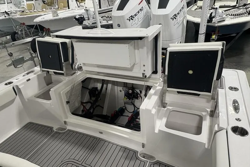 Slide: The Image of 2025 Tidewater 3100 Carolina Bay boat interior with open storage compartments and dual engines. - 44
