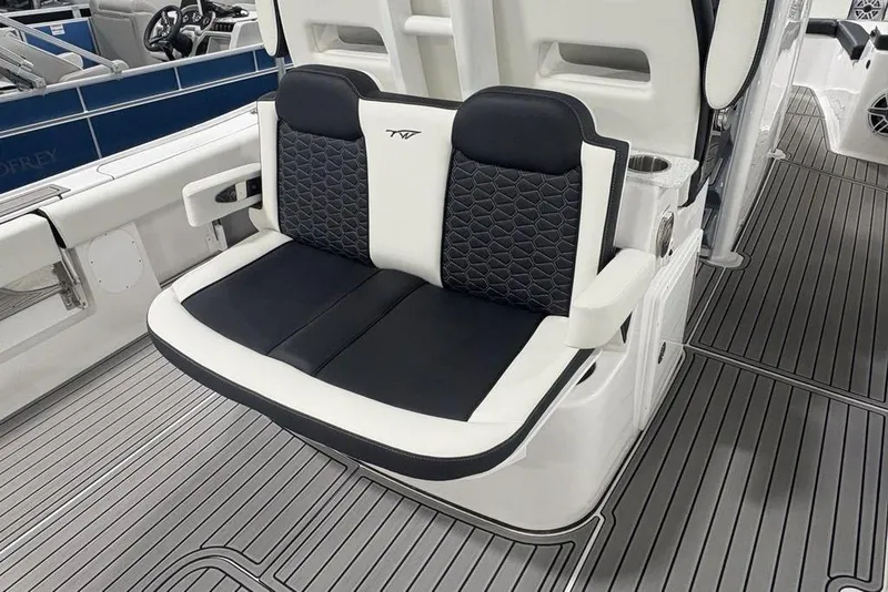 Slide: The Image of 2025 Tidewater 3100 Carolina Bay boat seat with black and white cushioned design. - 47