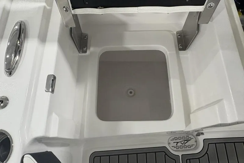 Slide: The Image of 2025 Tidewater 3100 Carolina Bay boat interior with storage compartment and stainless steel fixtures. - 48