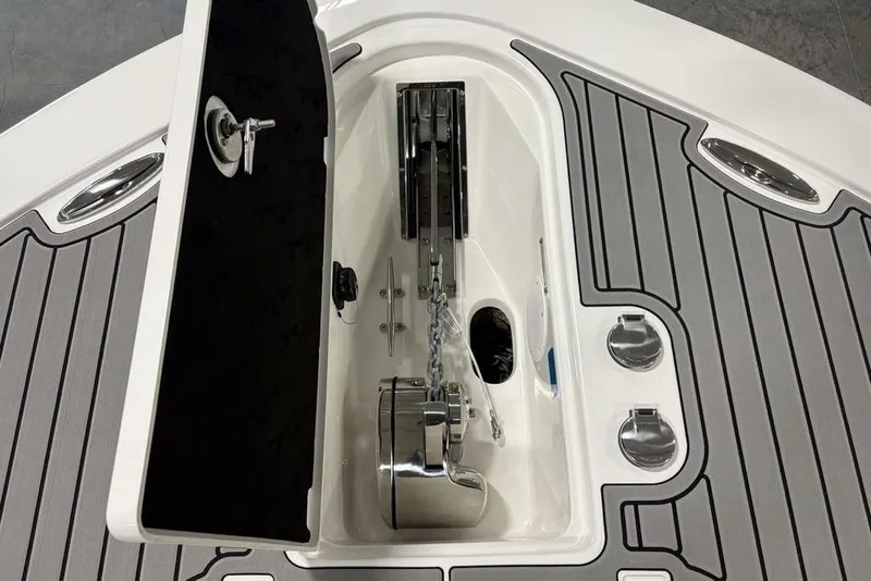 Slide: The Image of 2025 Tidewater 3100 Carolina Bay boat anchor compartment with open hatch and chain. - 5