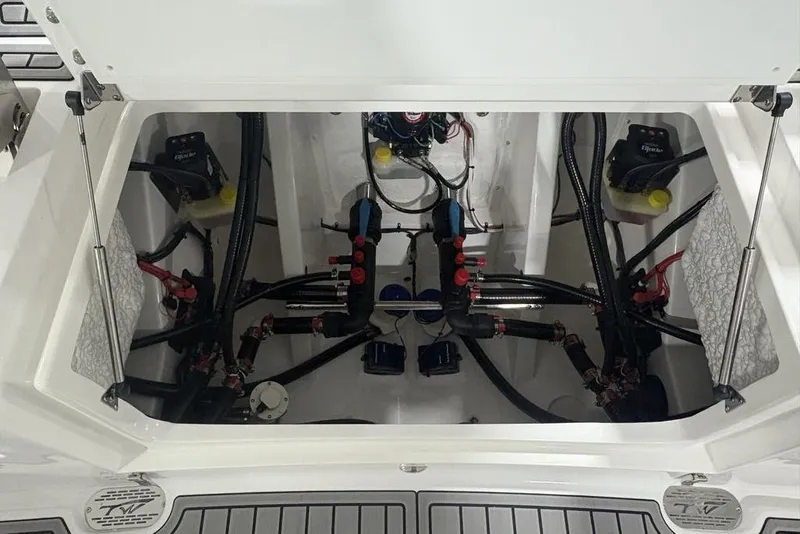 Slide: The Image of 2025 Tidewater 3100 Carolina Bay boat engine compartment with visible wiring and components. - 50
