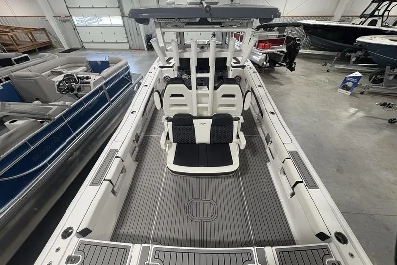 Slide: The Image of 2025 Tidewater 3100 Carolina Bay boat interior in showroom, featuring sleek seating and modern design. - 52