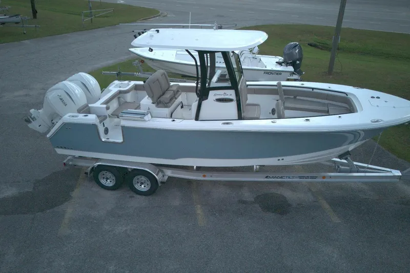 The Image of 2026 Sea Hunt Gamefish 25 boat on trailer, side view, parked outdoors. - 0
