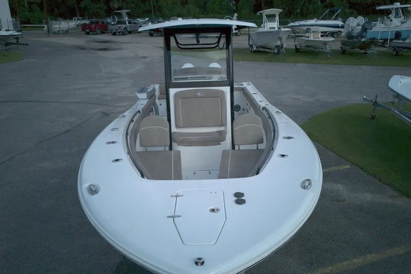 Slide: The Image of 2026 Sea Hunt Gamefish 25 boat, front view, parked in a marina. - 12