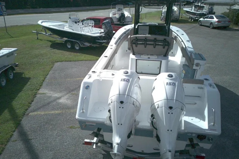 Slide: The Image of 2026 Sea Hunt Gamefish 25 boat with dual 150 engines, parked on a lot. - 13