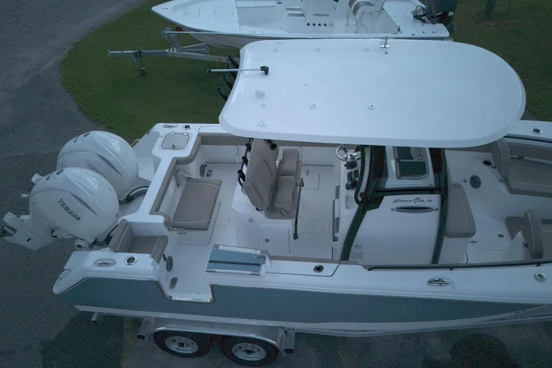 Slide: The Image of 2026 Sea Hunt Gamefish 25 boat with dual Yamaha engines, aerial view. - 6