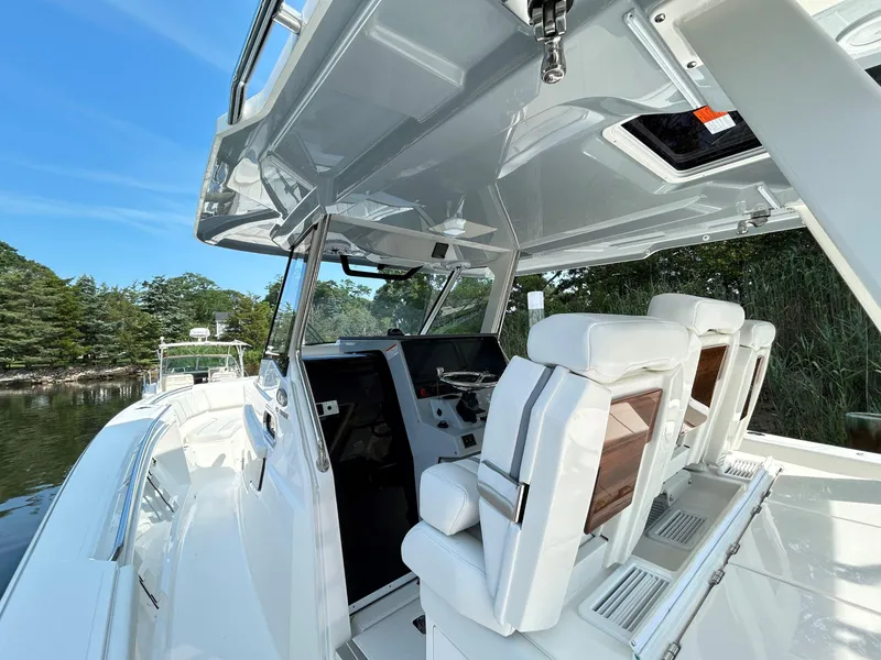 Slide: The Image of 2026 Pursuit S 358 boat interior with white seating and sleek design. - 11