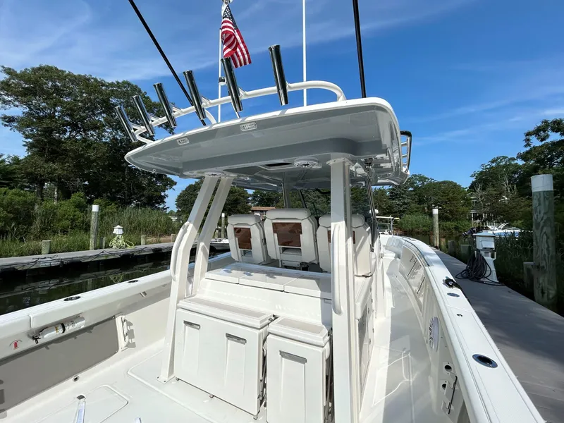 Slide: The Image of 2026 Pursuit S 358 boat docked, featuring a sleek design and fishing rod holders. - 5