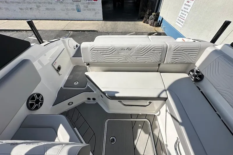Slide: The Image of 2026 Sea Ray SDX 230 Surf boat interior with white seating and modern design. - 17