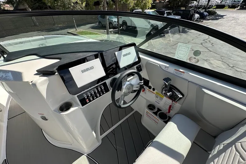 Slide: The Image of 2026 Sea Ray SDX 230 Surf boat cockpit with modern controls and dual Simrad displays. - 23