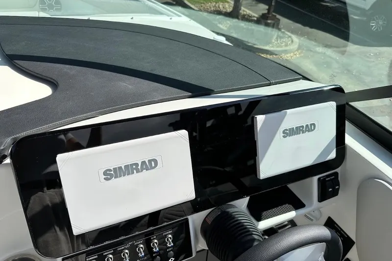 Slide: The Image of Dashboard of 2026 Sea Ray SDX 230 Surf with dual Simrad displays. - 24