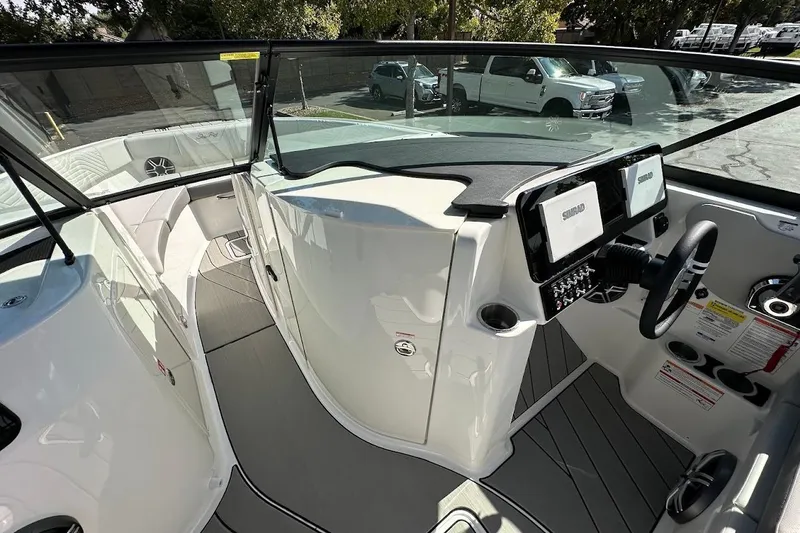 Slide: The Image of 2026 Sea Ray SDX 230 Surf boat interior with modern dashboard and seating. - 28