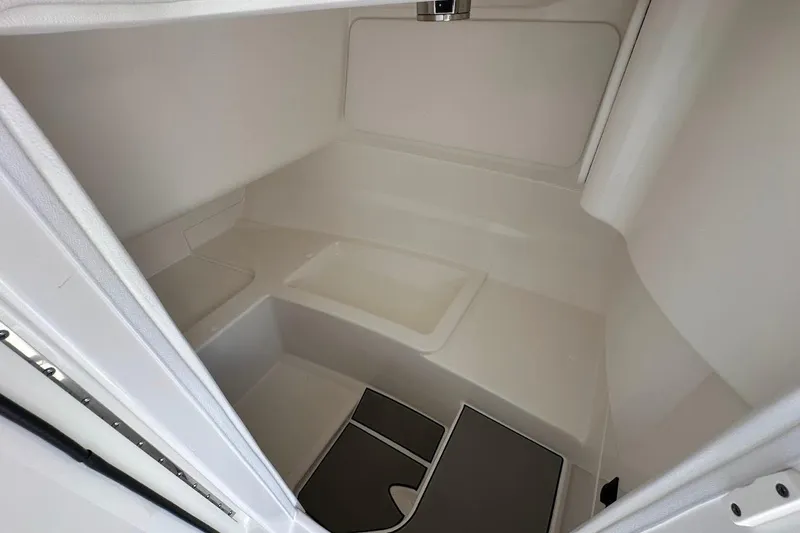 Slide: The Image of Interior cabin of 2026 Sea Ray SDX 230 Surf boat, featuring sleek white design. - 30