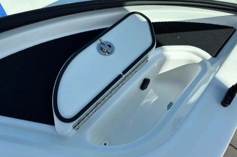 Slide: The Image of Storage compartment on 2026 Sea Ray SDX 230 Surf boat, featuring a secure latch. - 36