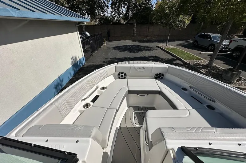 Slide: The Image of 2026 Sea Ray SDX 230 Surf boat interior with white seating and cup holders. - 38
