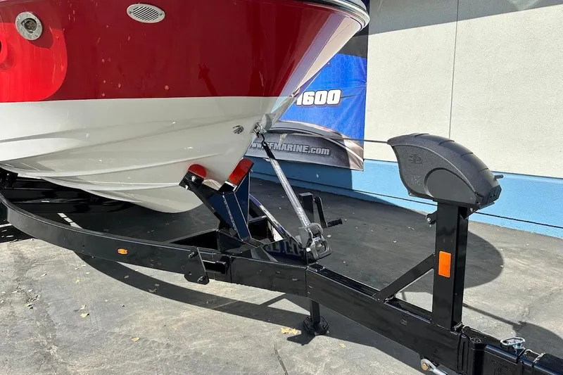 Slide: The Image of 2026 Sea Ray SDX 230 Surf boat on trailer, red and white hull. - 4