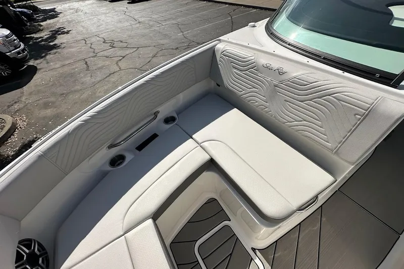 Slide: The Image of 2026 Sea Ray SDX 230 Surf boat interior with white cushioned seating and sleek design. - 41