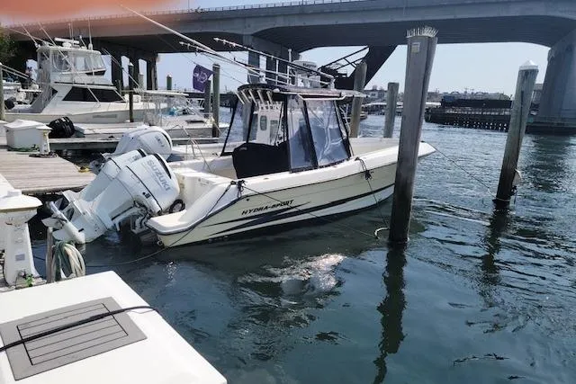 Slide: The Image of 2004 Hydra-Sports Vector 2600 CC boat docked with dual outboard engines. - 3