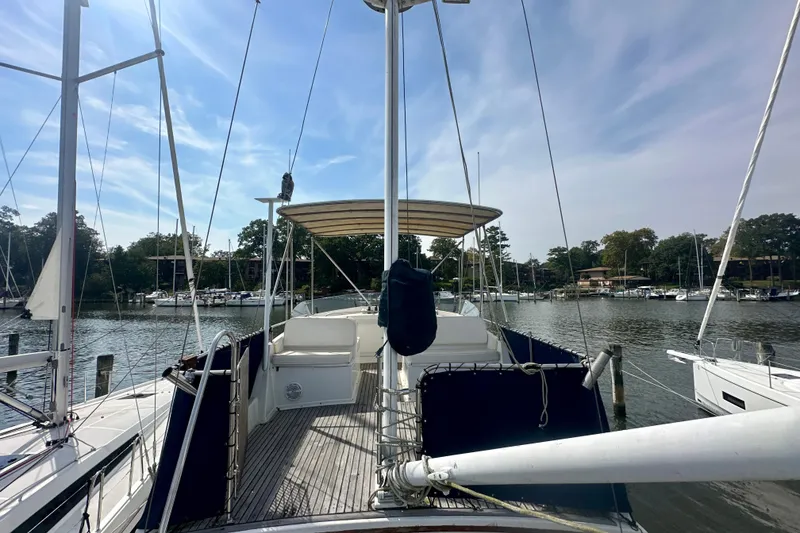 Slide: The Image of 1988 Grand Banks 36 Classic yacht docked at a marina under a clear sky. - 11