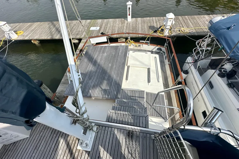 Slide: The Image of 1988 Grand Banks 36 Classic yacht docked, featuring spacious deck and wooden finish. - 12