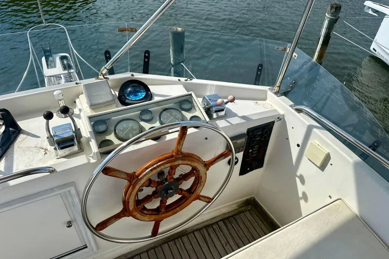 Slide: The Image of Helm of 1988 Grand Banks 36 Classic yacht with wooden steering wheel and navigational instruments. - 13