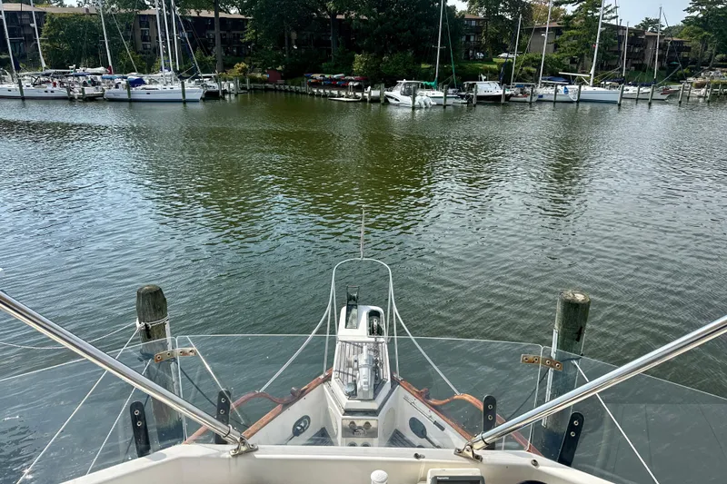 Slide: The Image of Bow view from 1988 Grand Banks 36 Classic yacht in a marina setting. - 14