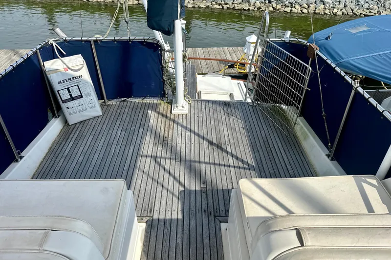 Slide: The Image of 1988 Grand Banks 36 Classic yacht deck with blue railings and safety equipment. - 17