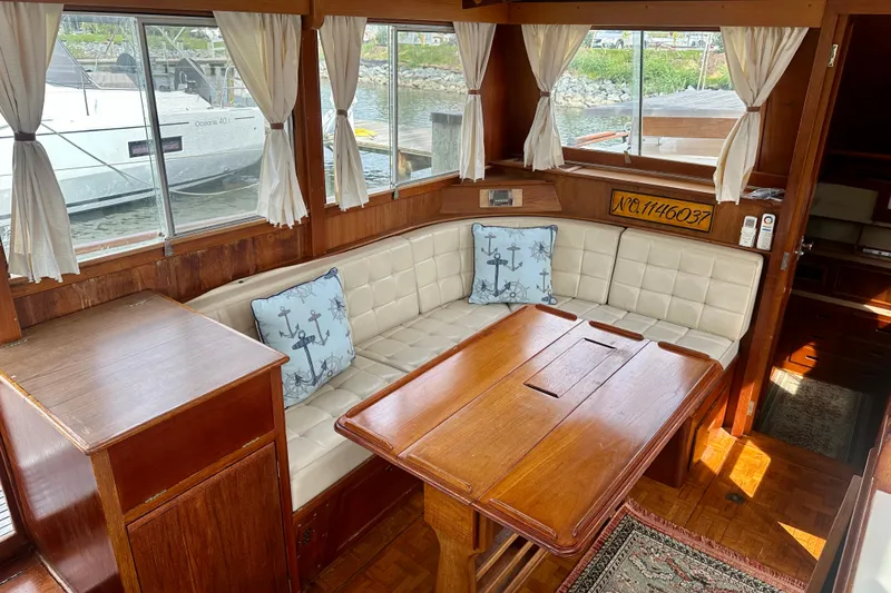 Slide: The Image of Interior of 1988 Grand Banks 36 Classic yacht with wood table and cushioned seating. - 20