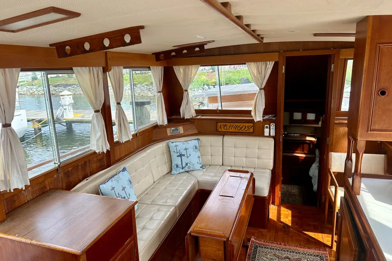 Slide: The Image of Interior of 1988 Grand Banks 36 Classic yacht with wood paneling and white seating. - 21