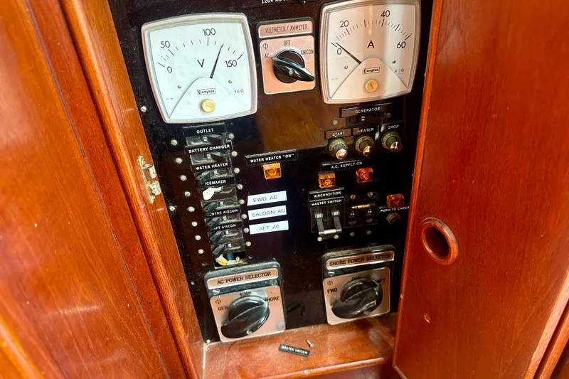 Slide: The Image of Electrical panel of a 1988 Grand Banks 36 Classic boat, featuring voltmeter and ammeter gauges. - 26