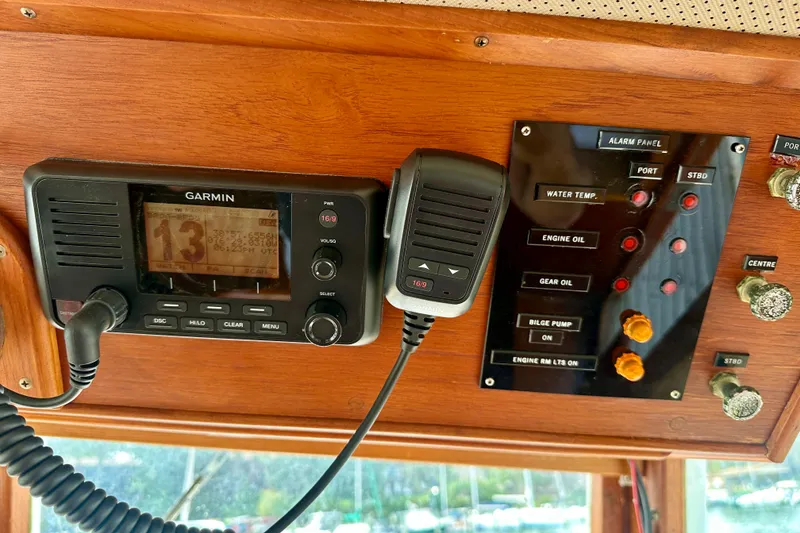 Slide: The Image of Control panel of a 1988 Grand Banks 36 Classic with Garmin radio and alarm indicators. - 27