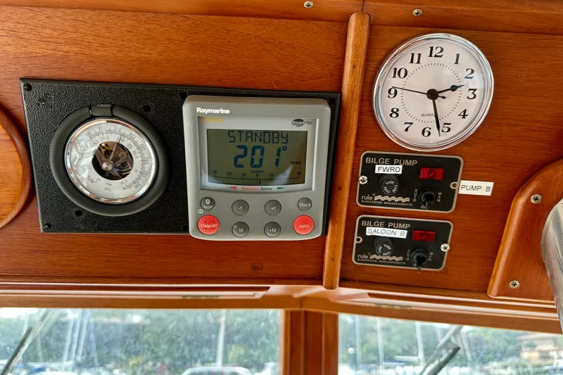 Slide: The Image of Control panel of a 1988 Grand Banks 36 Classic boat with instruments and bilge pump switches. - 30