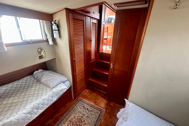 Slide: The Image of Cabin interior of 1988 Grand Banks 36 Classic with wooden finishes and twin beds. - 37