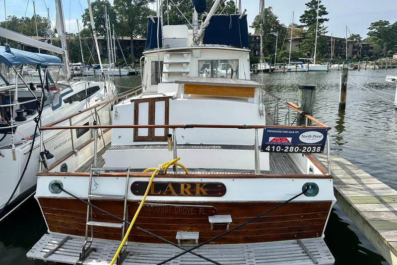 Slide: The Image of 1988 Grand Banks 36 Classic yacht docked, named "Lark," for sale in marina setting. - 4