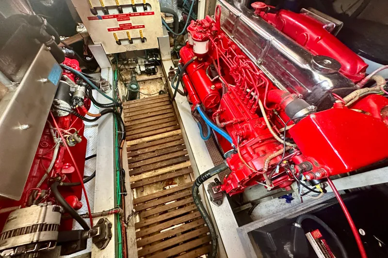Slide: The Image of Engine room of 1988 Grand Banks 36 Classic with red machinery and wooden flooring. - 41