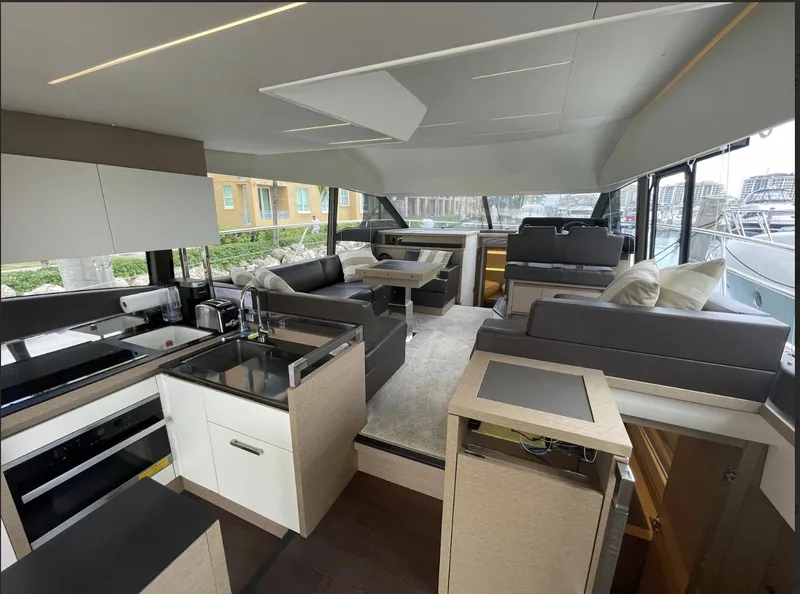 Slide: The Image of Luxurious interior of a 2018 Prestige 520 yacht with modern kitchen and seating area. - 11